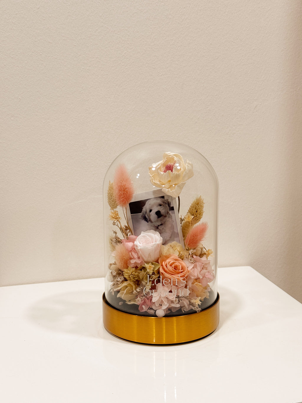 Preserved flower dome with your own photo as a memory capsule, styled in a lighted glass dome on a gold base. Crafted by Eden's Ground, a floral design boutique.