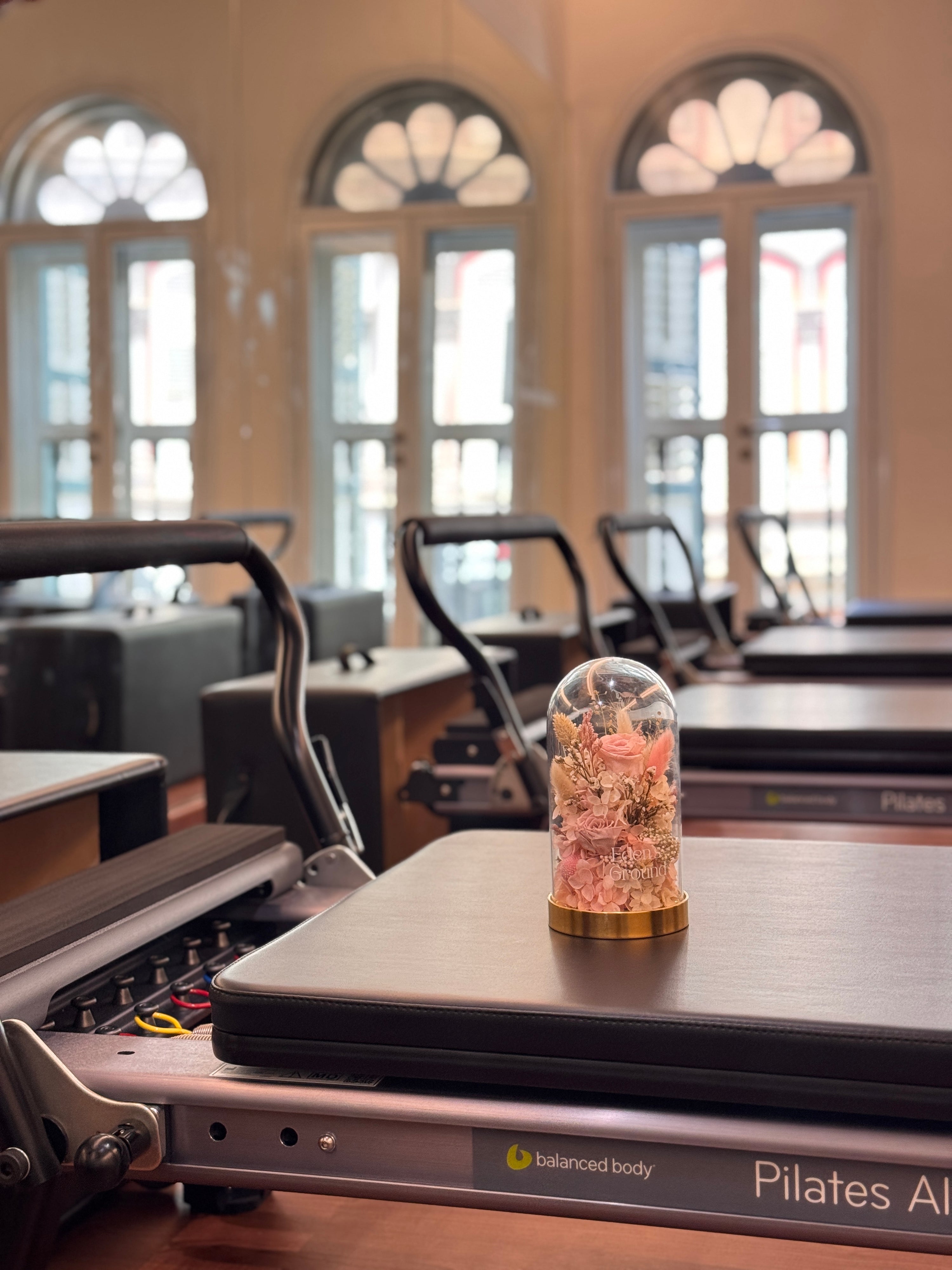 Celebrate Mother’s Day 2025 with a pilates reformer workout by REIGN Pilates, followed by a lighted preserved flower dome arrangement workshop by Eden’s Ground.
