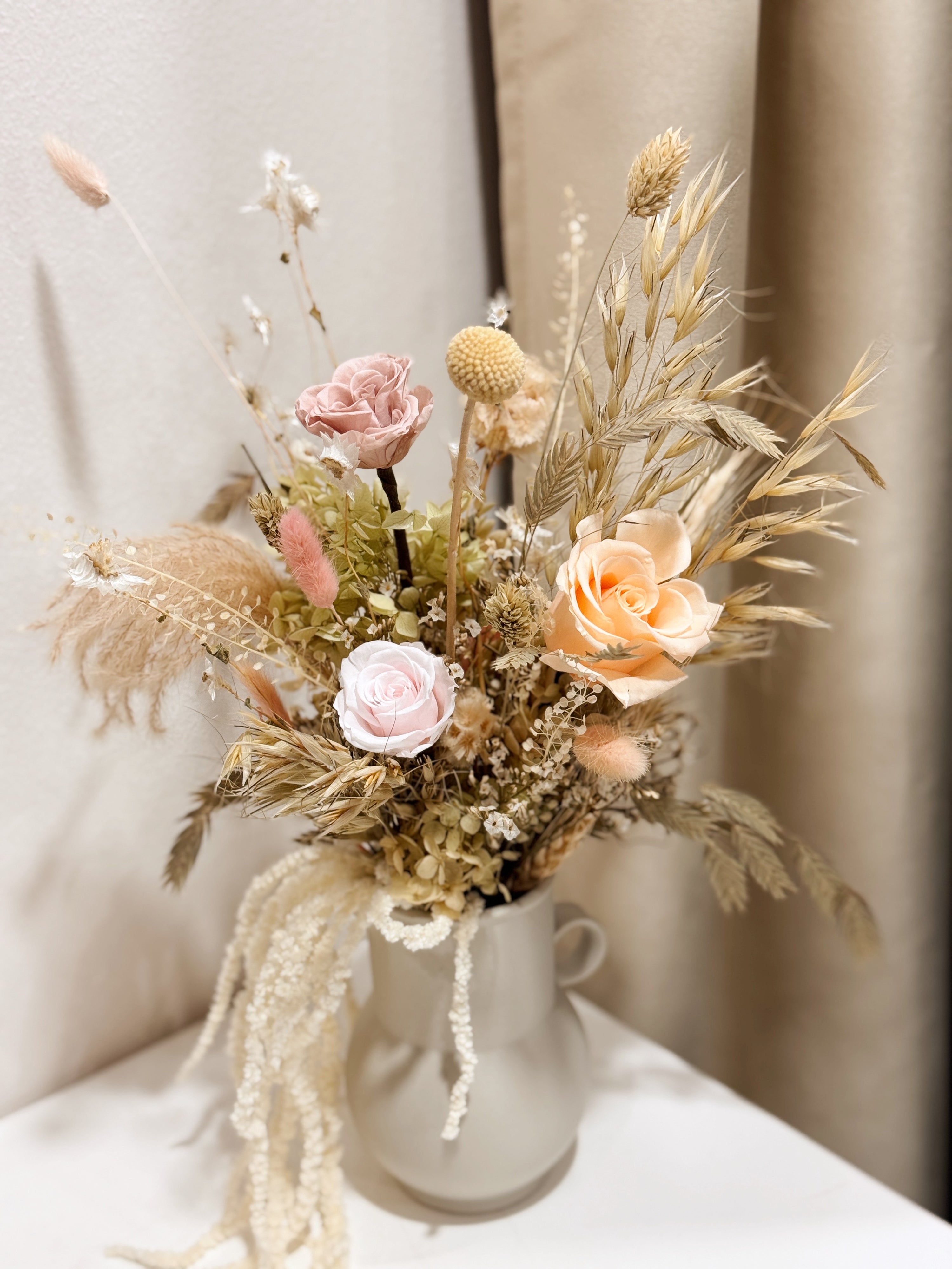 My Cup Runneth Over vase arrangement by Eden’s Ground featuring everlasting florals in soft, earthy tones, with amaranthus spilling over — thoughtfully styled in a mini jug vase. Low-maintenance and long-lasting, it's perfect as a housewarming gift or as a timeless piece of home décor.