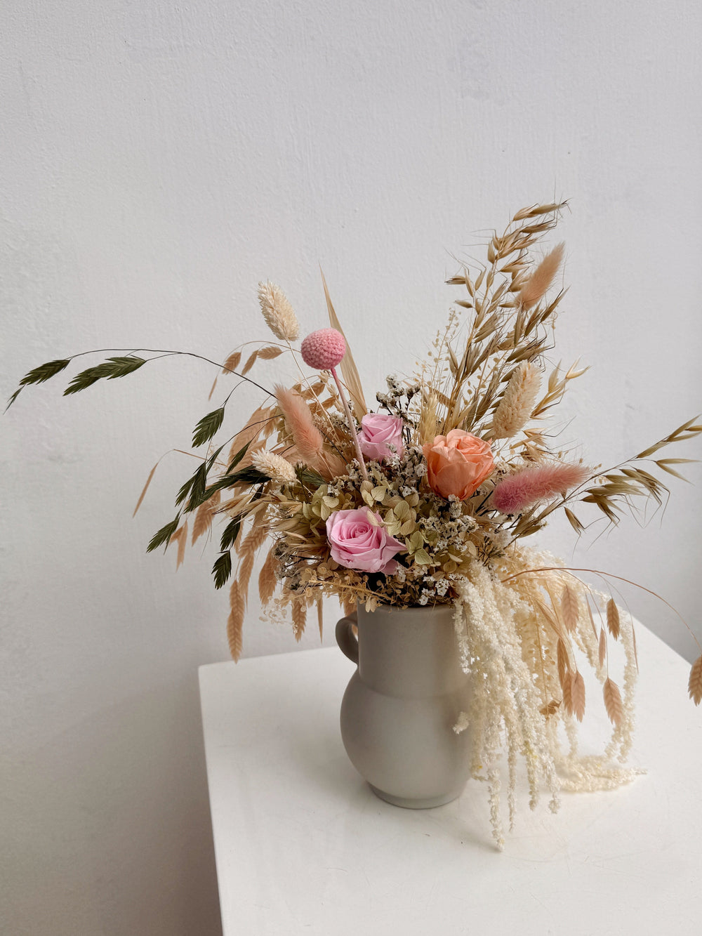 My Cup Runneth Over vase arrangement by Eden’s Ground featuring everlasting florals in soft, earthy tones, with amaranthus spilling over — thoughtfully styled in a mini jug vase. Low-maintenance and long-lasting, it's perfect as a housewarming gift or as a timeless piece of home décor.