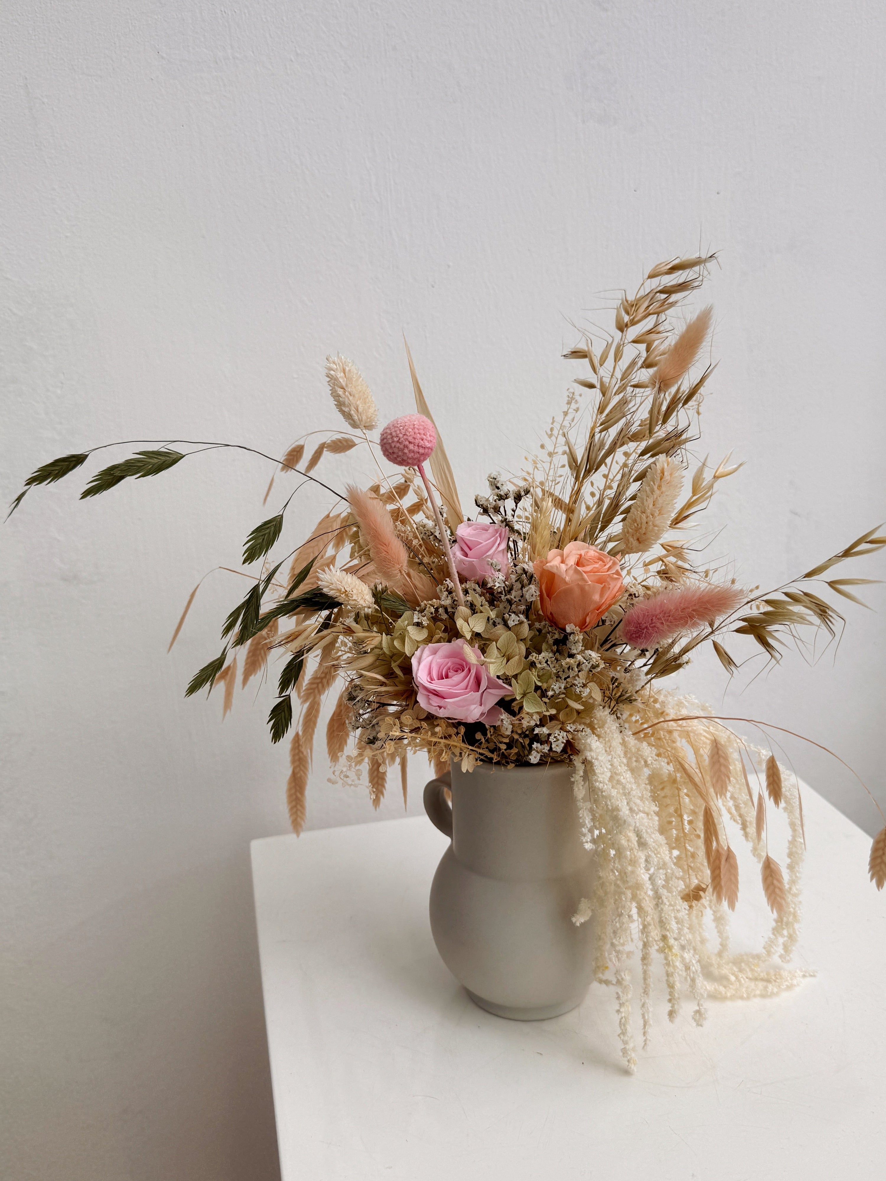 My Cup Runneth Over vase arrangement by Eden’s Ground featuring everlasting florals in soft, earthy tones, with amaranthus spilling over — thoughtfully styled in a mini jug vase. Low-maintenance and long-lasting, it's perfect as a housewarming gift or as a timeless piece of home décor.