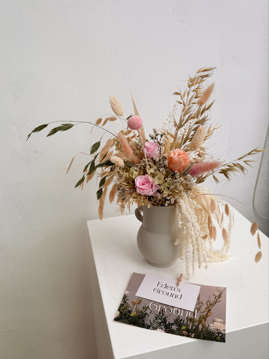 My Cup Runneth Over vase arrangement by Eden’s Ground featuring everlasting florals in soft, earthy tones, with amaranthus spilling over — thoughtfully styled in a mini jug vase. Low-maintenance and long-lasting, it's perfect as a housewarming gift or as a timeless piece of home décor.