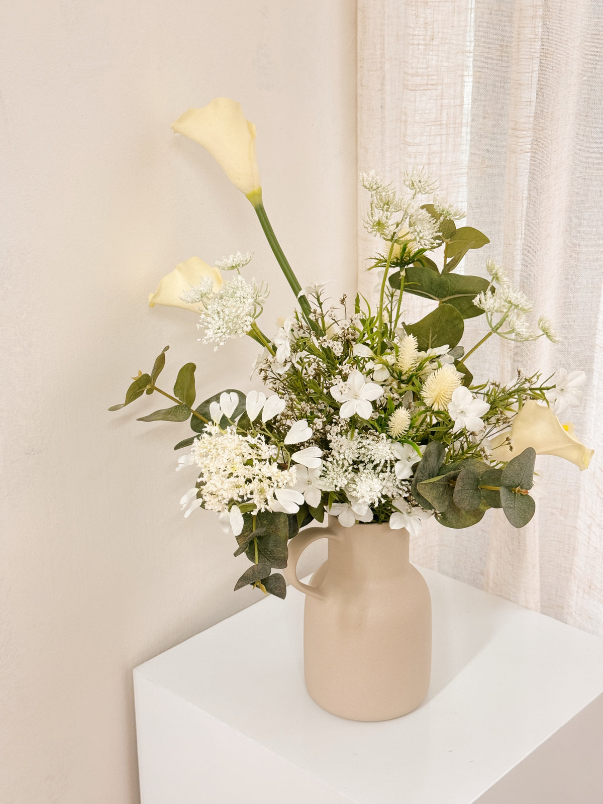 Pearl Veil Faux Flower vase arrangement by Eden’s Ground featuring life like fake flowers in soft white, earthy green tones — thoughtfully styled in a vase. Low-maintenance and long-lasting, it's perfect as a housewarming gift or as a timeless piece of home décor.