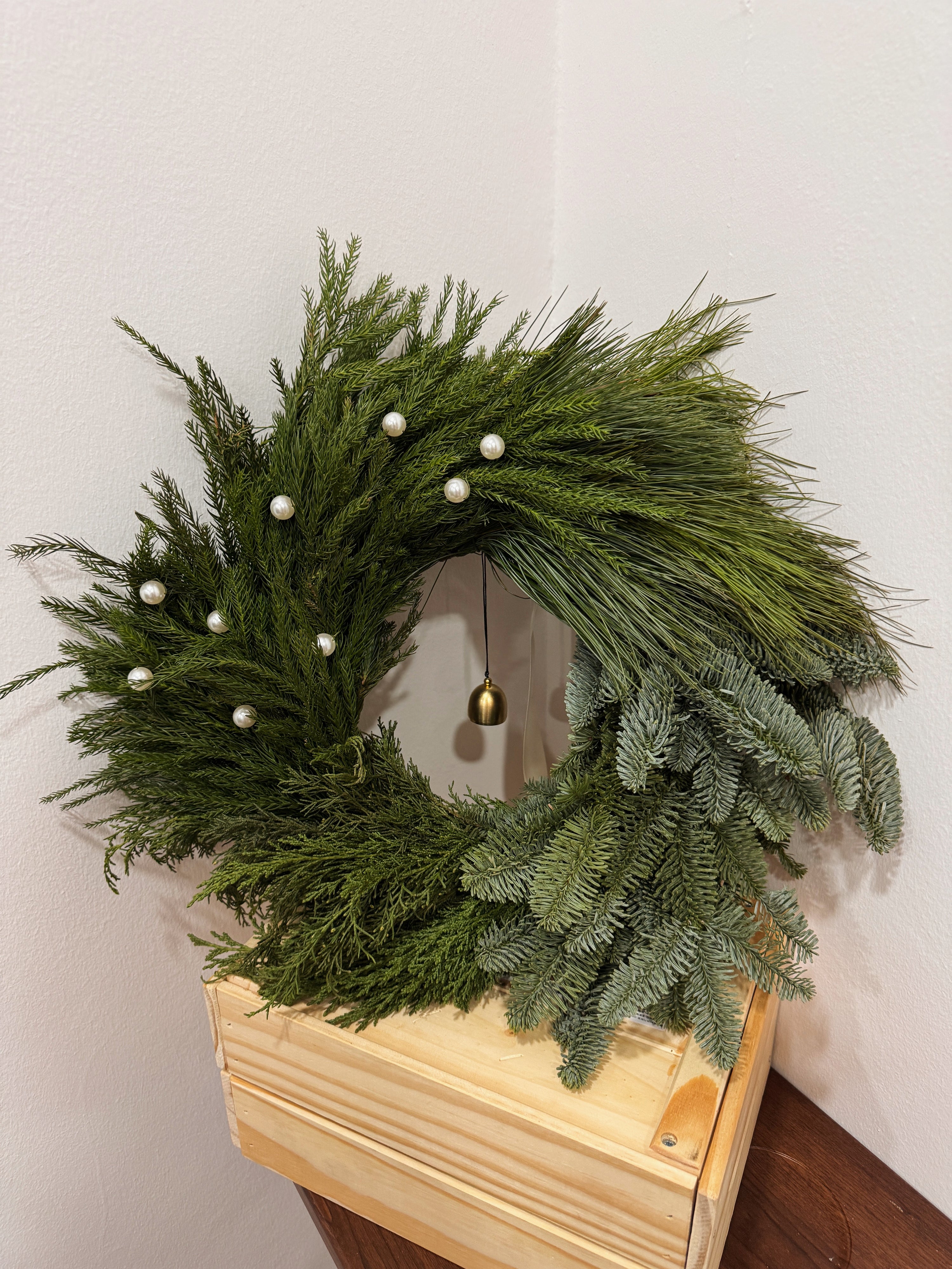 Fresh Christmas Wreath, decorated with pearls and bell by Eden's Ground, a Floral Design Studio in Singapore.