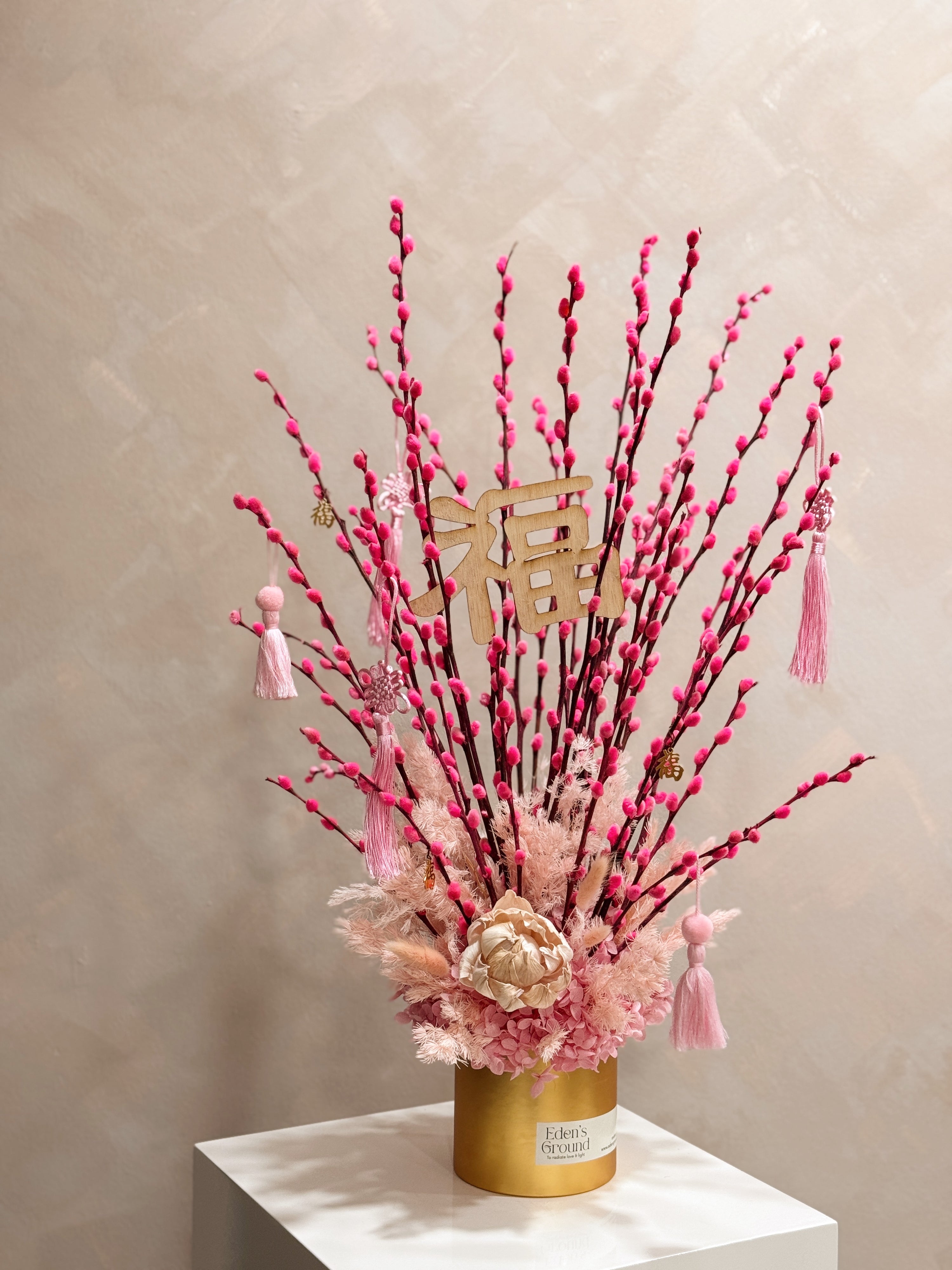 Chinese New Year 2026 Pussy Willow Flower Box, featuring pink and gold pussy willow cny flower, everlasting preserved hydrangeas, decorated with pink tassles and 福 to usher in wealth, abundance, prosperity and all the good vibes for the lunar new year, crafted by Eden's Ground, a floral design studio in Singapore. Delivered straight to your doorstep.