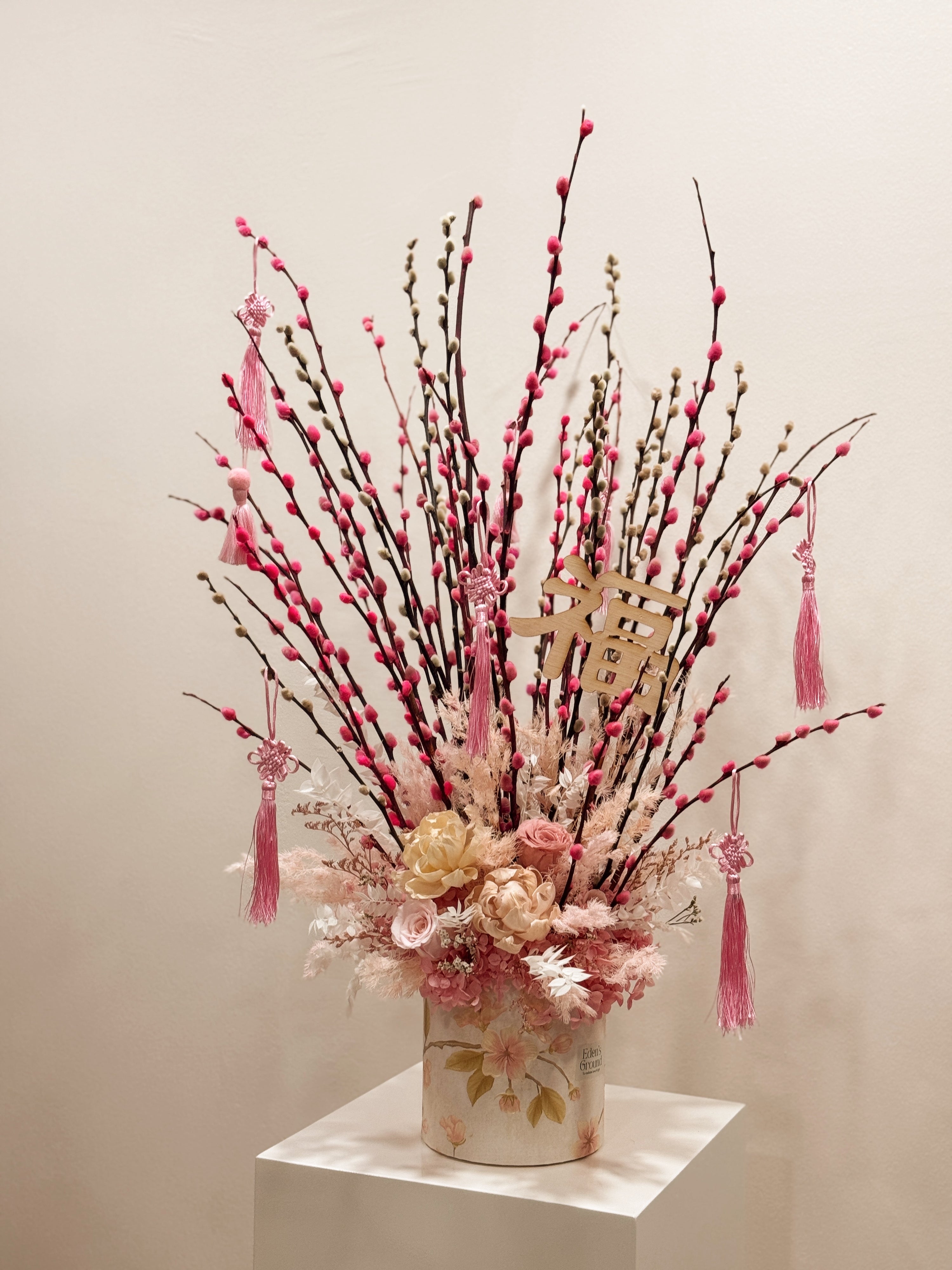 Chinese New Year 2026 Pussy Willow Flower Box, featuring pink and white pussy willow cny flower, everlasting preserved peonies with roses, decorated with pink tassles and 福 to usher in wealth, abundance, prosperity and all the good vibes for the lunar new year, crafted by Eden's Ground, a floral design studio in Singapore.