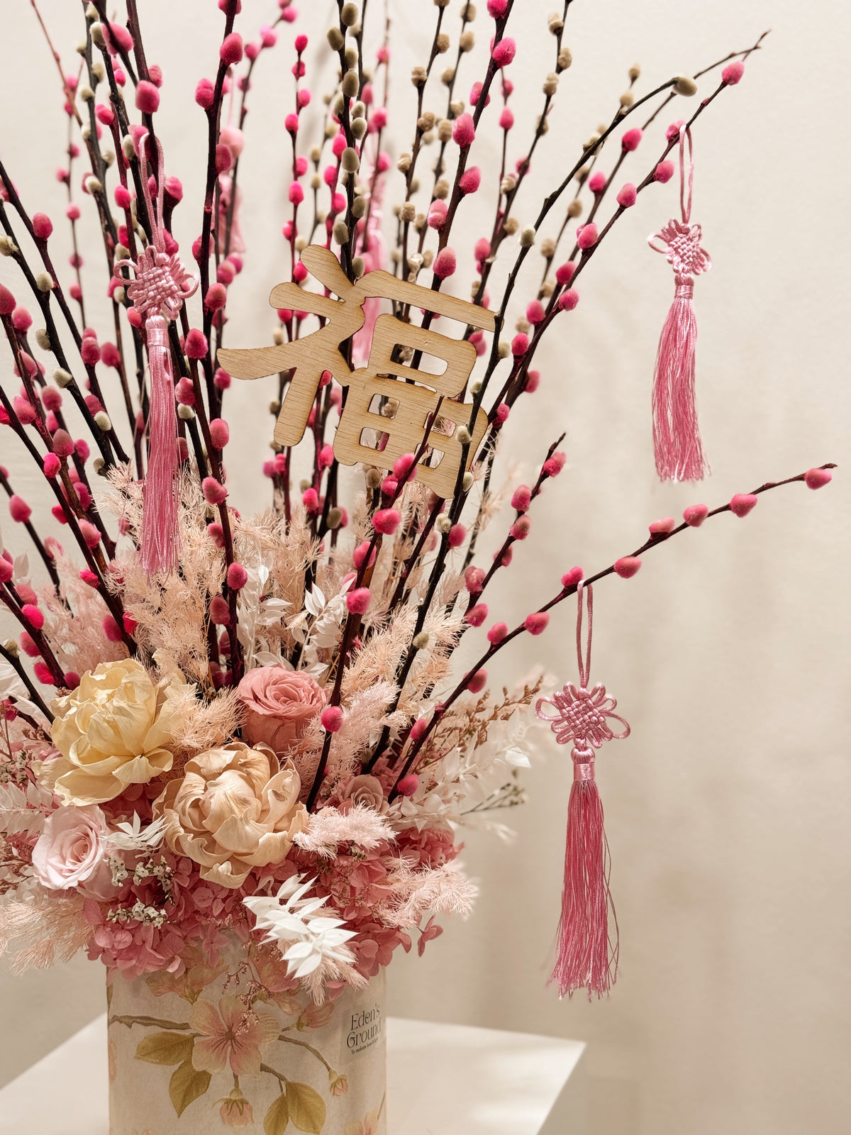 Chinese New Year 2026 Pussy Willow Flower Box, CNY 2026 Flowers, featuring pink and white pussy willow cny flower, everlasting preserved peonies with roses, decorated with pink tassles and 福 to usher in wealth, abundance, prosperity and all the good vibes for the lunar new year, crafted by Eden's Ground, a floral design studio in Singapore. Delivered straight to your doorstep.
