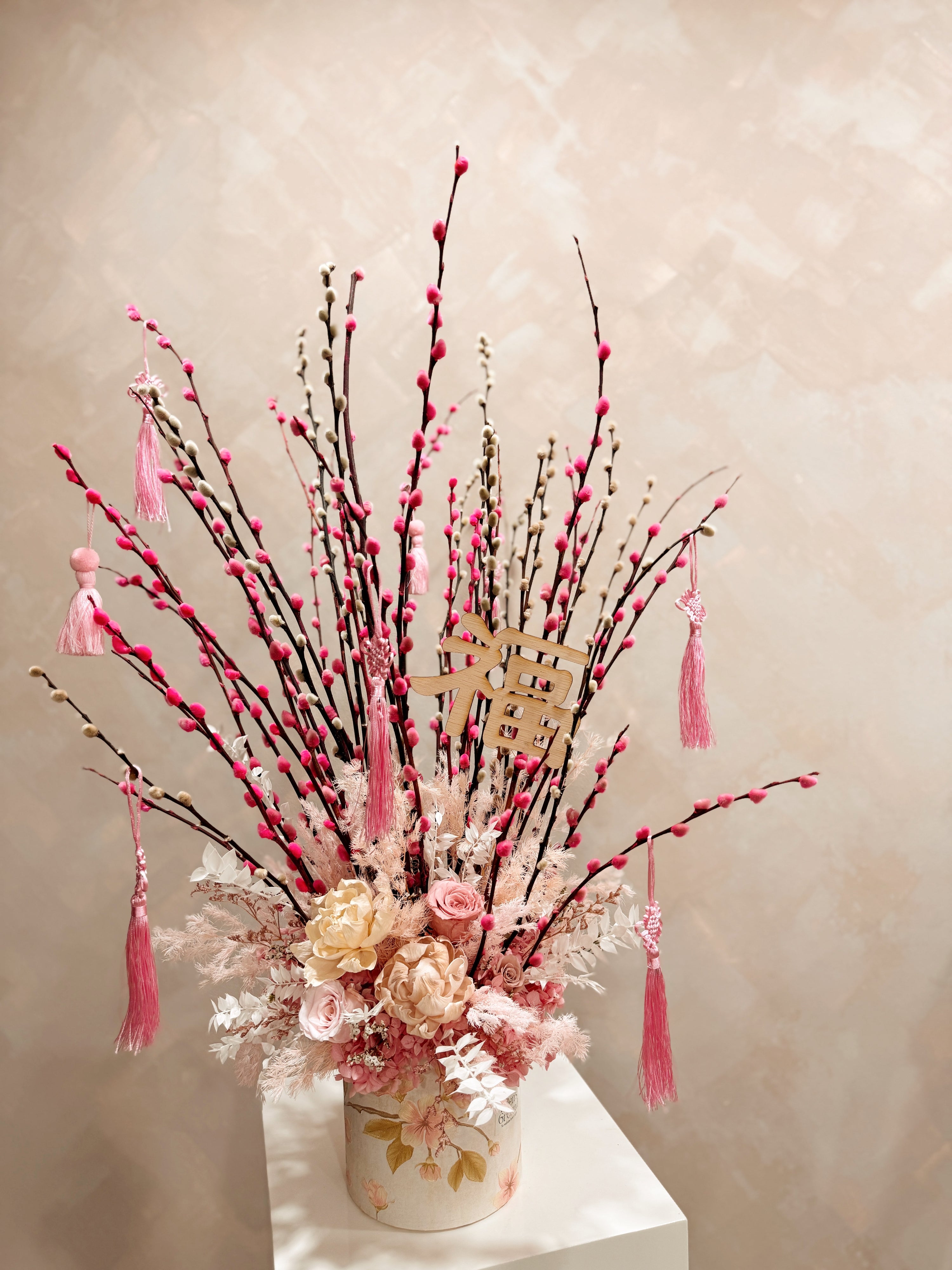 Chinese New Year 2026 Pussy Willow Flower Box, featuring pink and white pussy willow cny flower, everlasting preserved peonies with roses, decorated with pink tassles and 福 to usher in wealth, abundance, prosperity and all the good vibes for the lunar new year, crafted by Eden's Ground, a floral design studio in Singapore.