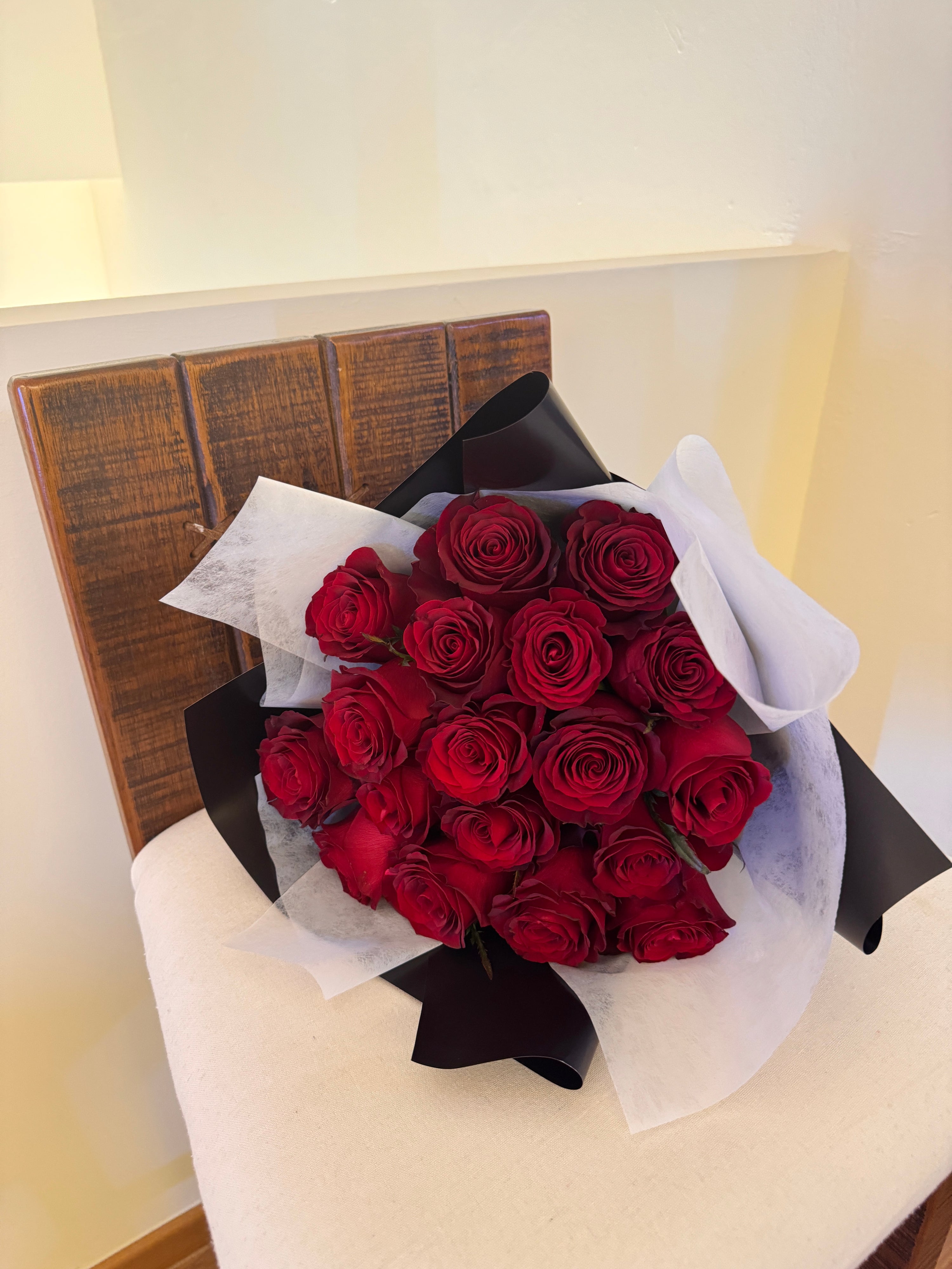 Classic red roses bouquet wrapped in black paper crafted by Eden’s Ground.