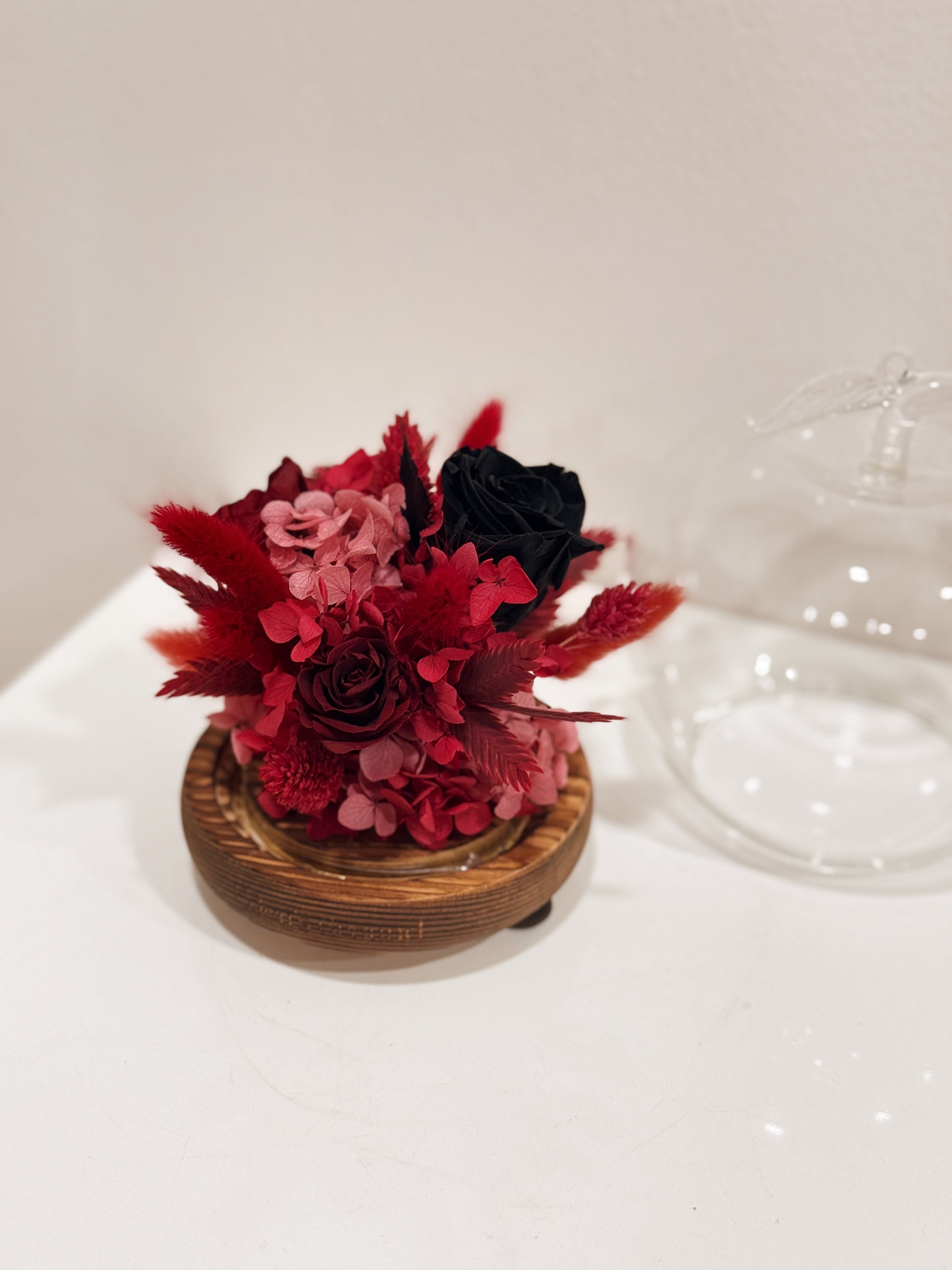 Snow white enchanted apple flower dome, inspired by fairy-tale, made with delicate blend of preserved and dried flowers in deep red tones, beautifully arranged in a lighted apple-shaped glass dome by Eden’s Ground—an enchanting keepsake made to last. 