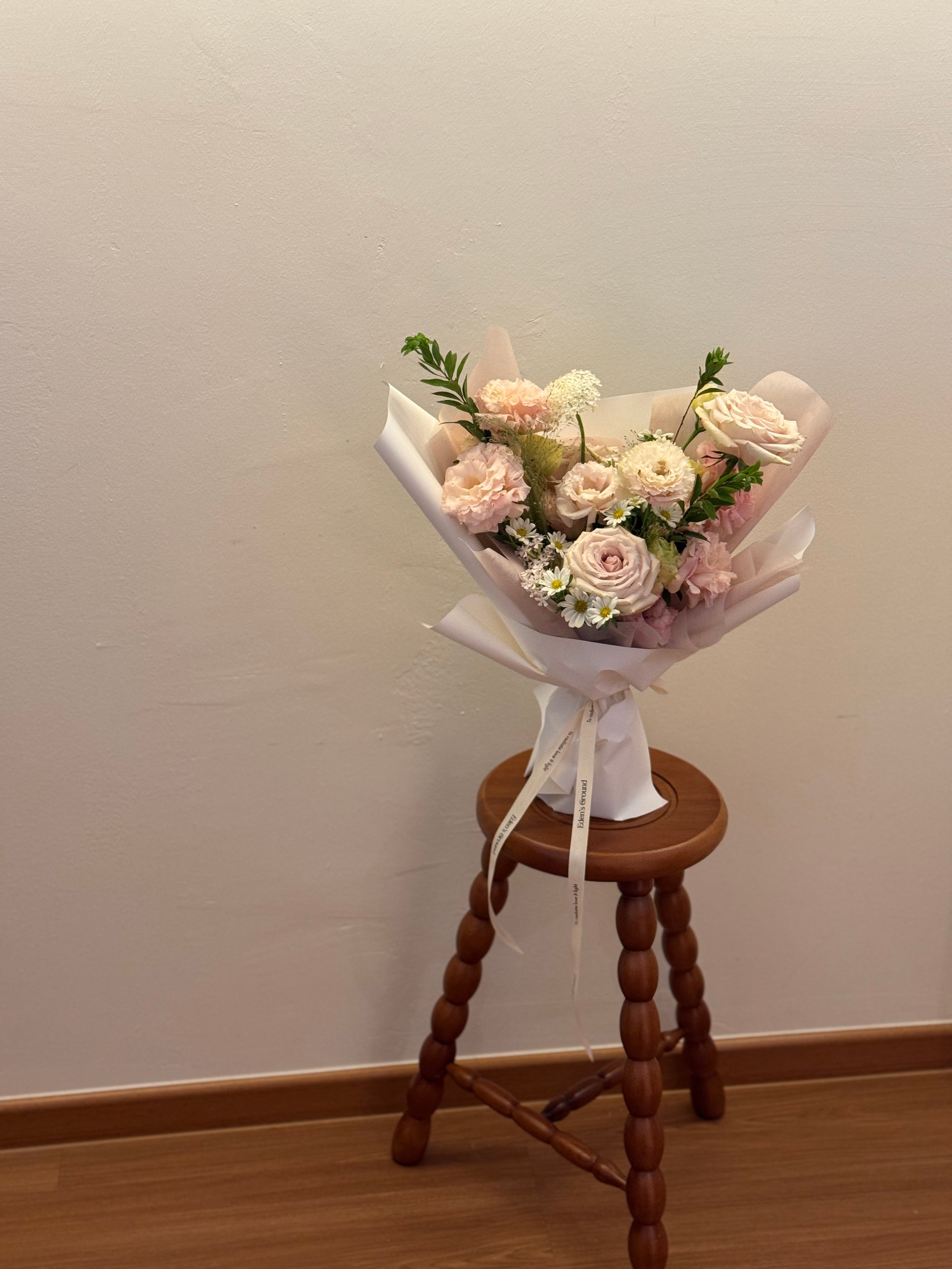Light pink garden roses and flowers inspired by korean-style bouquets, wrapped in white tissue paper and white glassine paper crafted by Eden’s Ground. Perfect for Valentine's day for expressing gentle love.