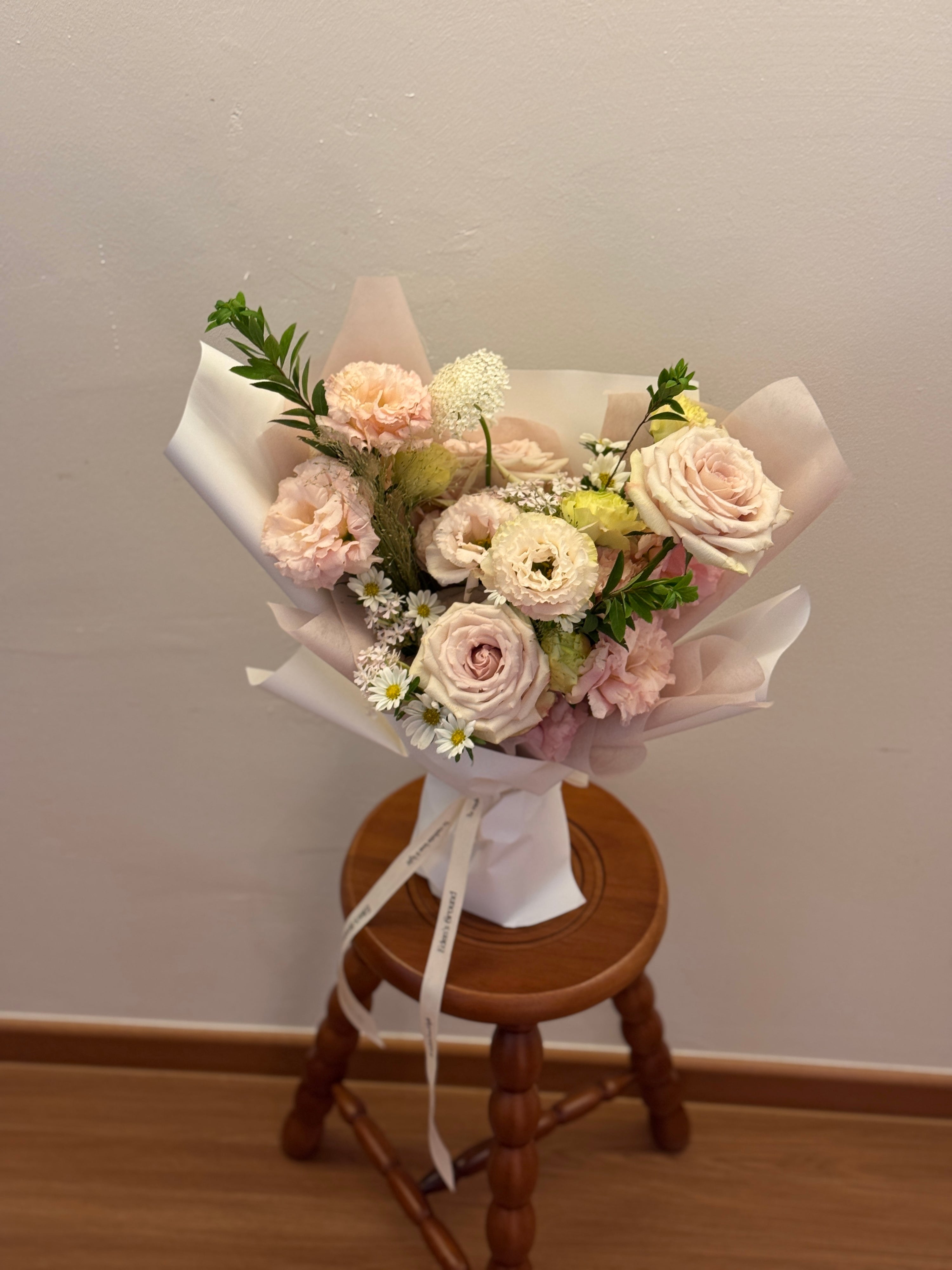 Light pink garden roses and flowers inspired by korean-style bouquets, wrapped in white tissue paper and white glassine paper crafted by Eden’s Ground. Perfect for Valentine's day for expressing gentle love.