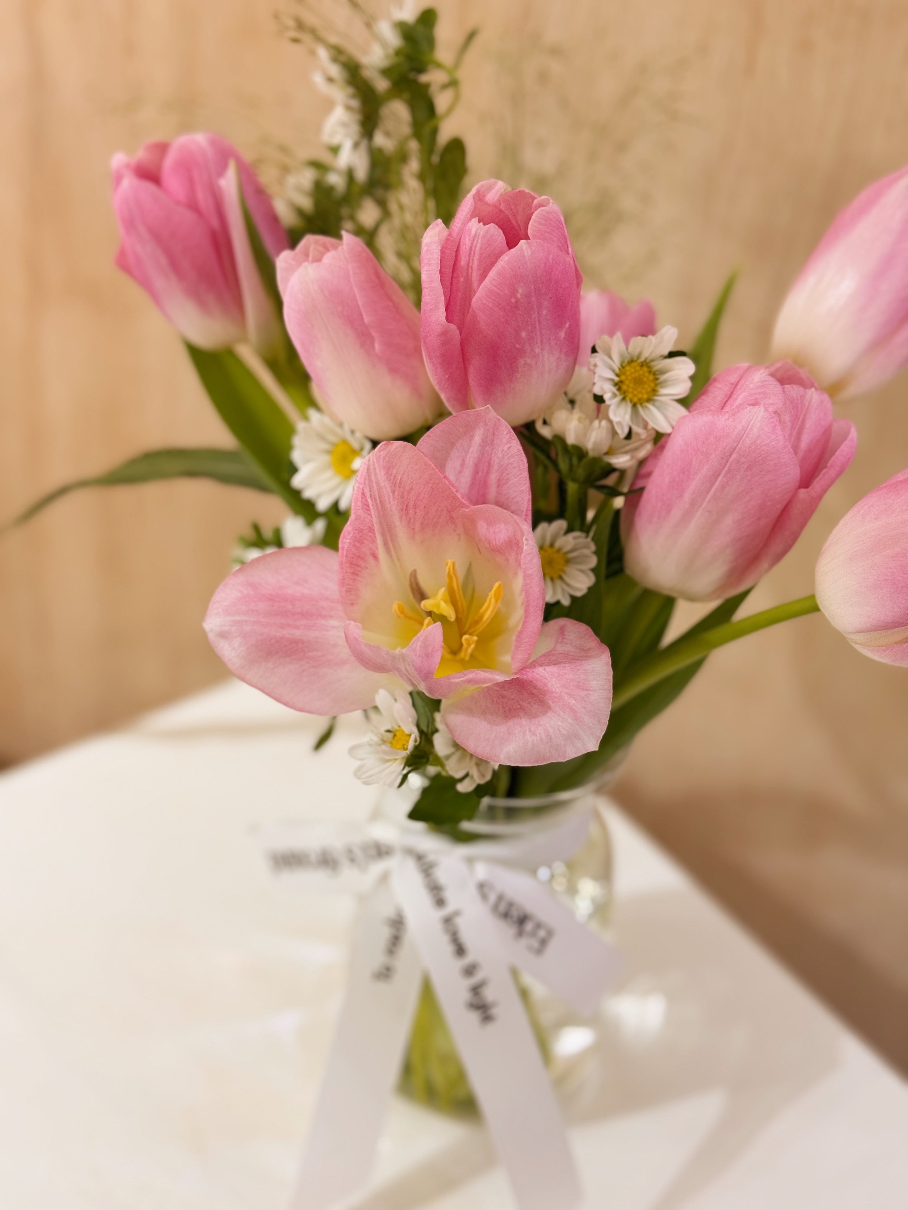 Valentine's tulips in a small vase like jar, featuring vibrant pink tulips with lots of daisies crafted by Eden’s Ground, a floral design boutique based in Singapore.