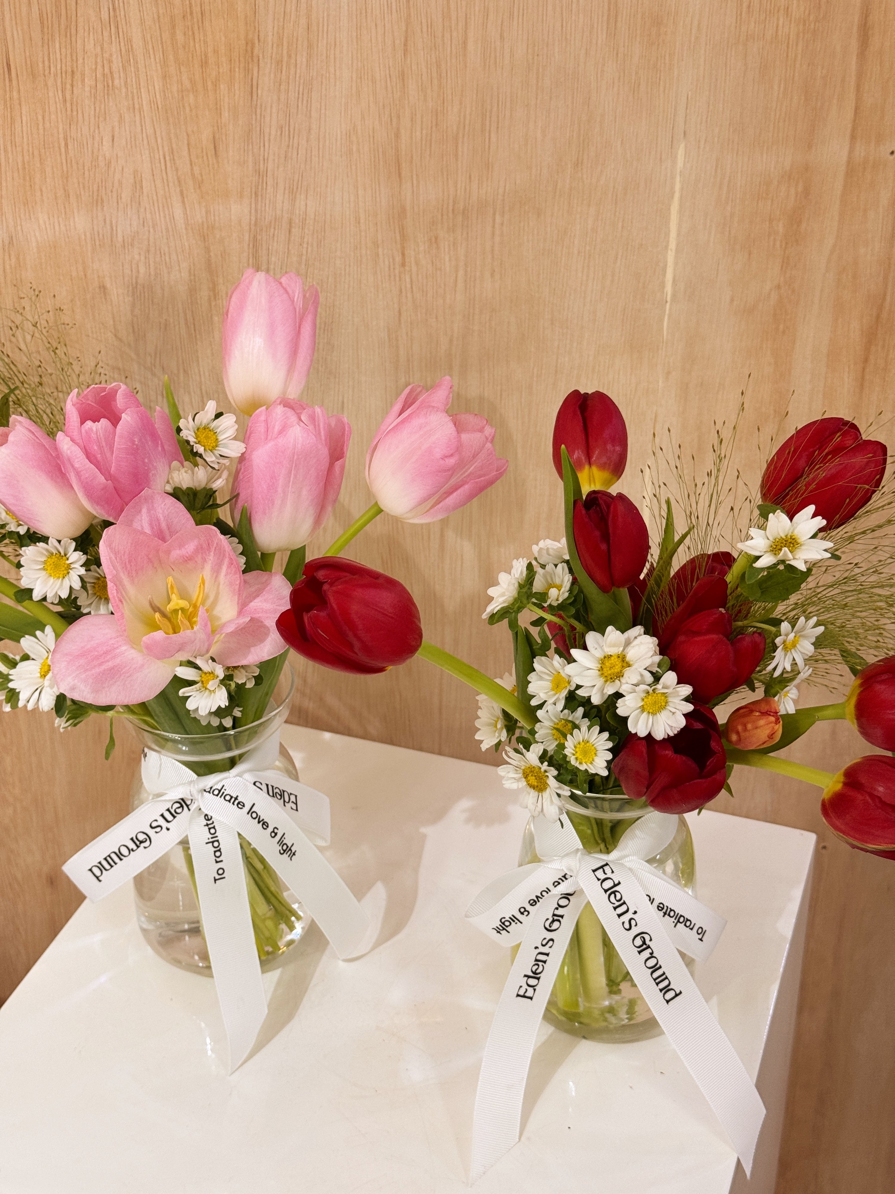 Valentine's tulips in a small vase like jar, featuring vibrant red or pink tulips with lots of daisies crafted by Eden’s Ground, a floral design boutique based in Singapore.