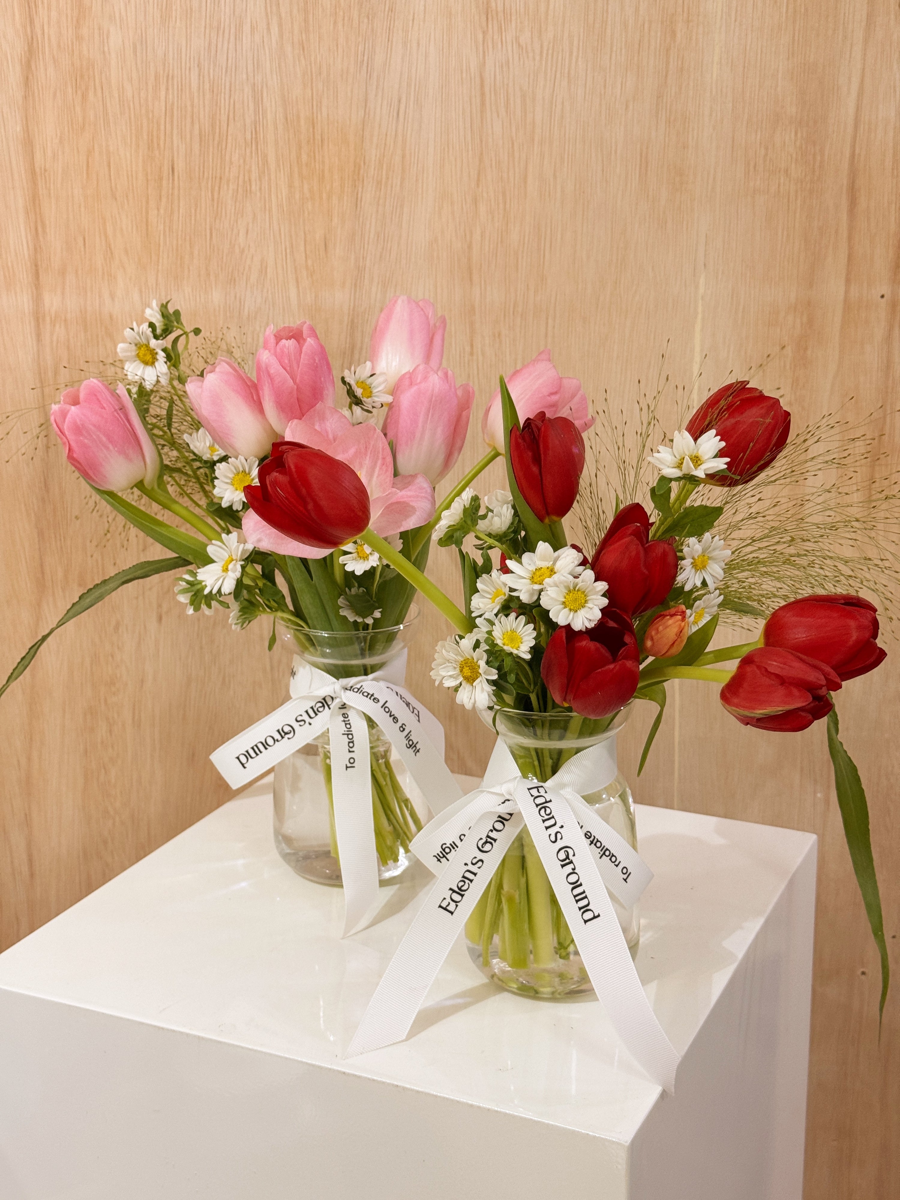 Valentine's tulips in a small vase like jar, featuring vibrant red or pink tulips with lots of daisies crafted by Eden’s Ground, a floral design boutique based in Singapore.