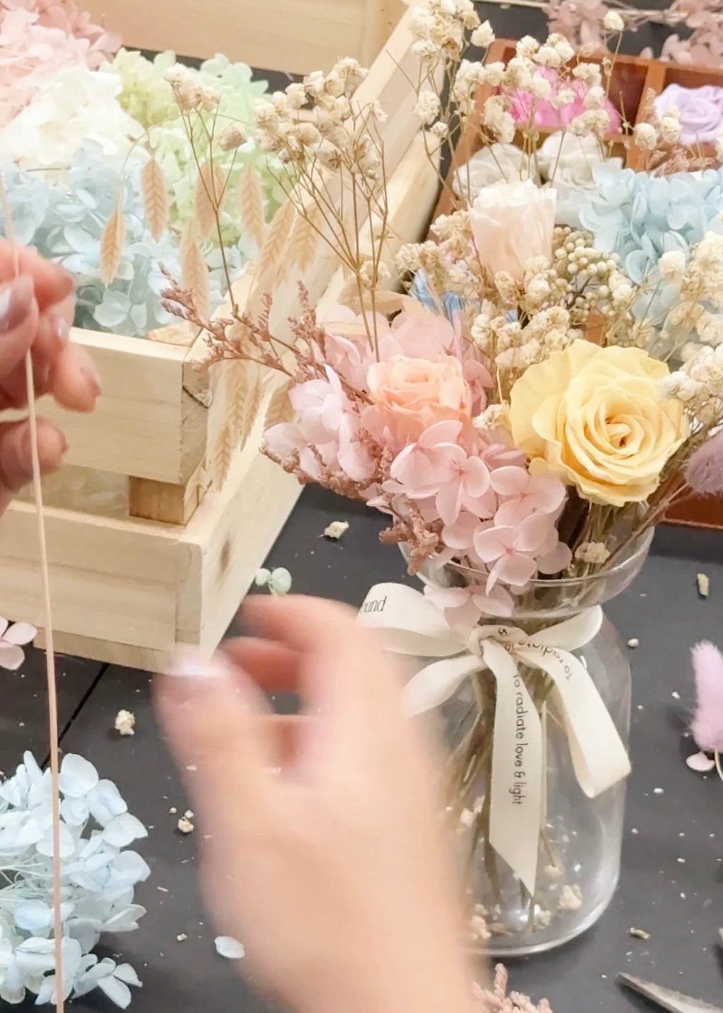 A preserved and dried flower vase arrangement workshop, in soft green and neutral tones. Guided by Eden's Ground, a floral design boutique.