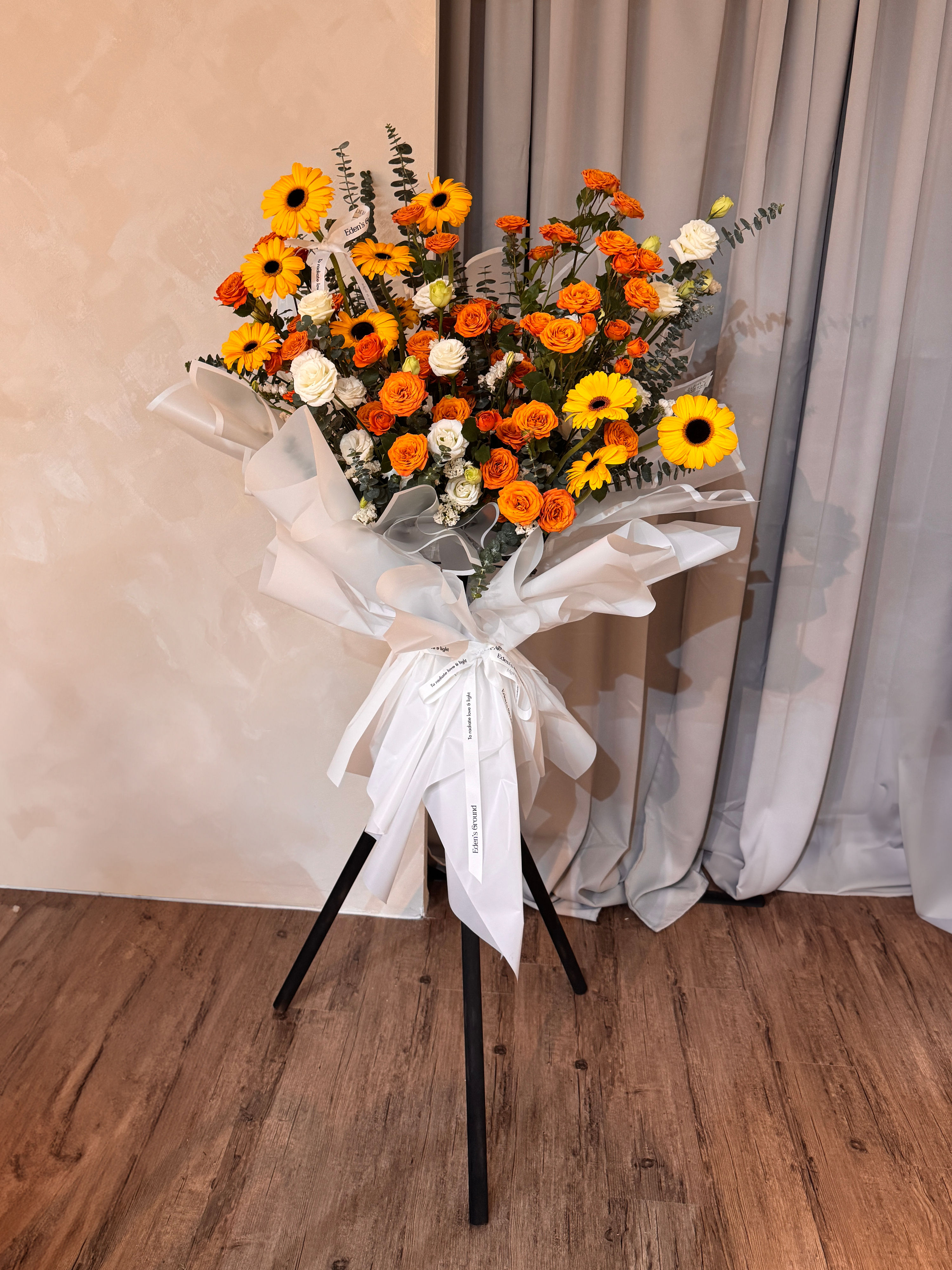 Warmest Congratulations, Fresh Flower Congratulatory Stand, featuring vibrant Roses, cheerful Gerbera, and the fresh touch of eucalyptus, crafted by Eden's Ground, a floral design boutique based in Singapore.