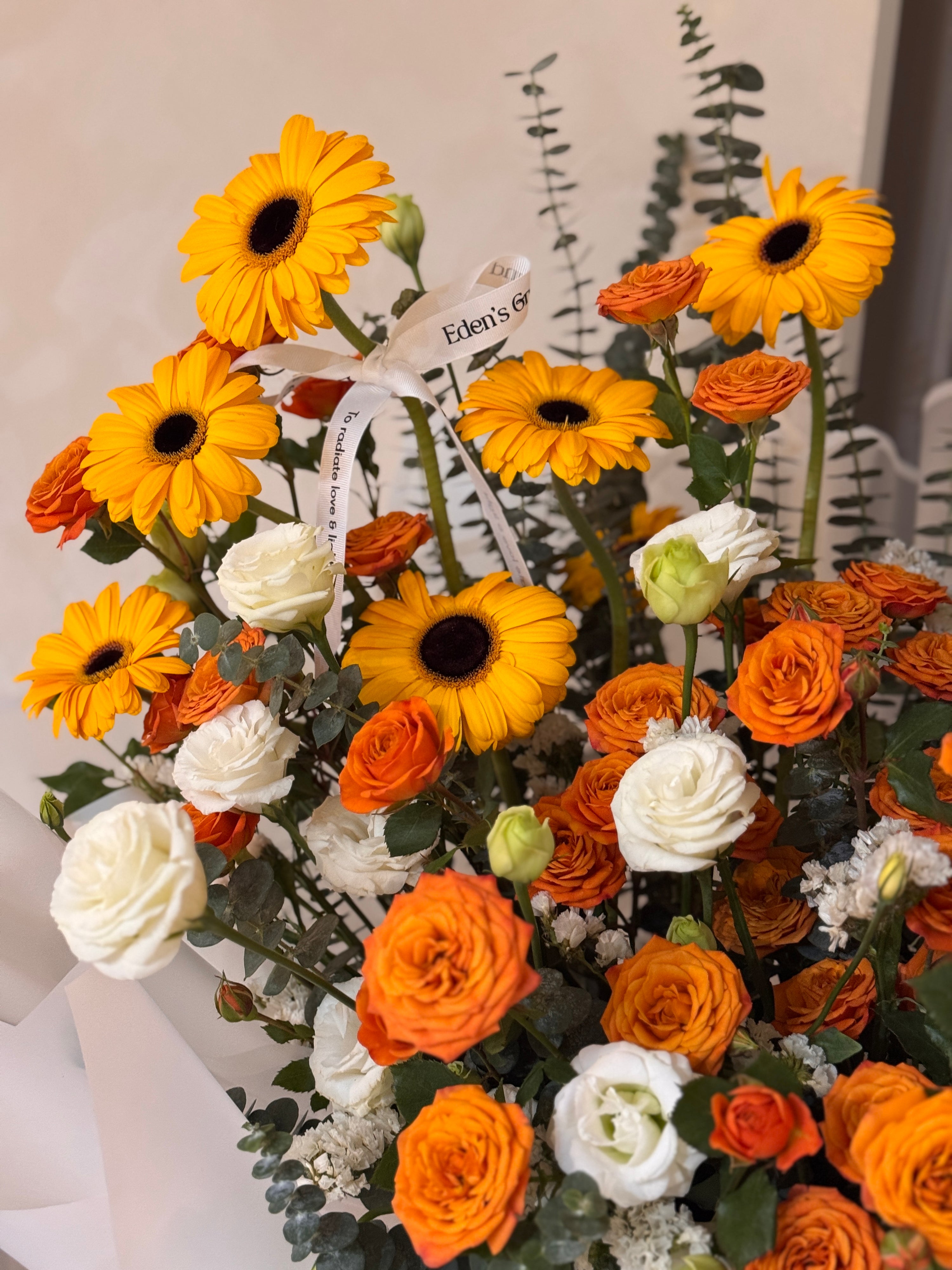 Warmest Congratulations, Fresh Flower Congratulatory Stand, featuring vibrant Roses, cheerful Gerbera, and the fresh touch of eucalyptus, crafted by Eden's Ground, a floral design boutique based in Singapore.