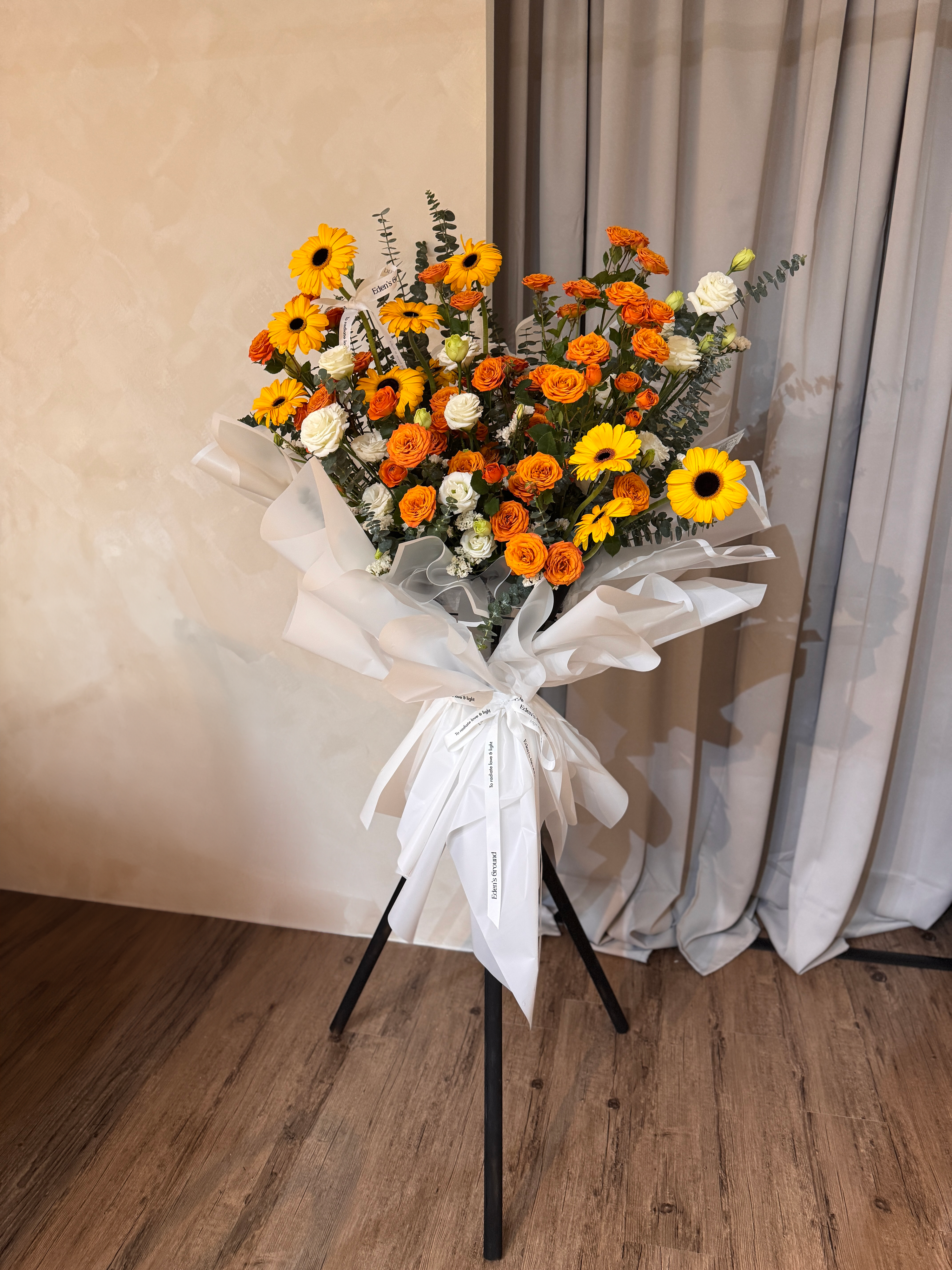 Warmest Congratulations, Fresh Flower Congratulatory Stand, featuring vibrant Roses, cheerful Gerbera, and the fresh touch of eucalyptus, crafted by Eden's Ground, a floral design boutique based in Singapore.
