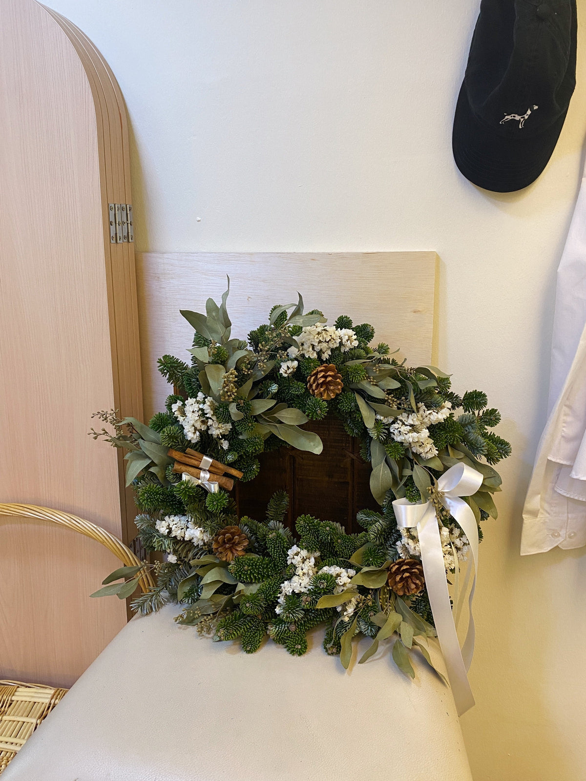 Fresh Christmas Wreath, decorated with baubles, ornaments, cotton, pinecones, cinnamon sticks and more by Eden's Ground, a Floral Design Studio in Singapore.