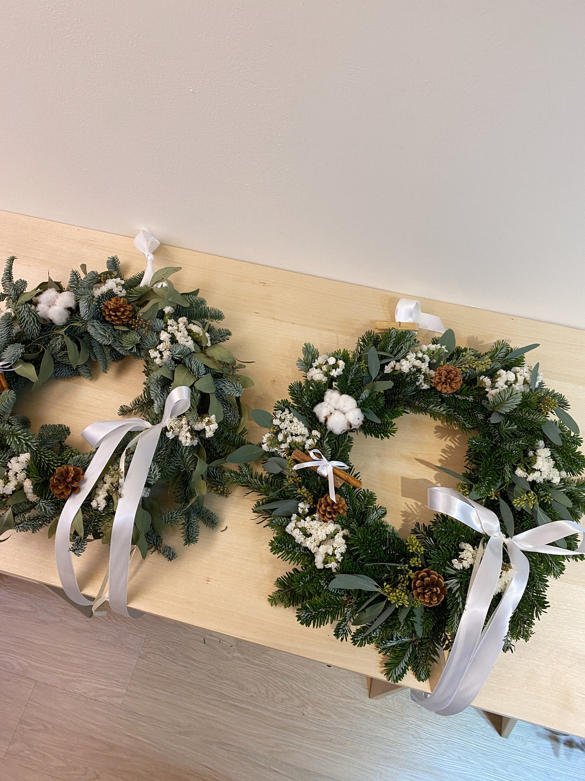 Fresh Christmas Wreath, decorated with baubles, ornaments, cotton, pinecones, cinnamon sticks and more by Eden's Ground, a Floral Design Studio in Singapore.