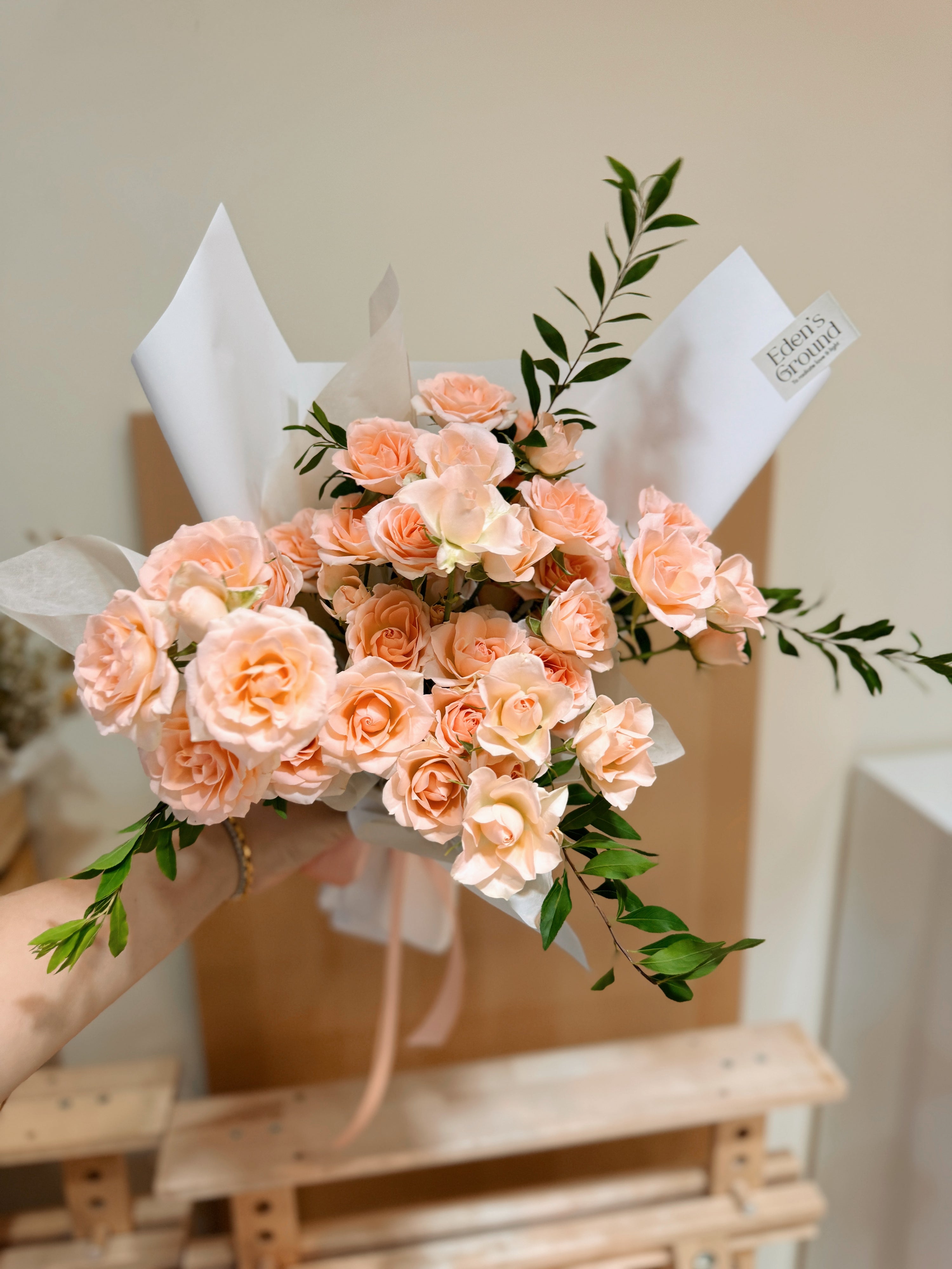 Pink spray roses, sweet and romantic bouquet, wrapped in tissue paper and brown kraft paper, crafted by Eden's Ground.