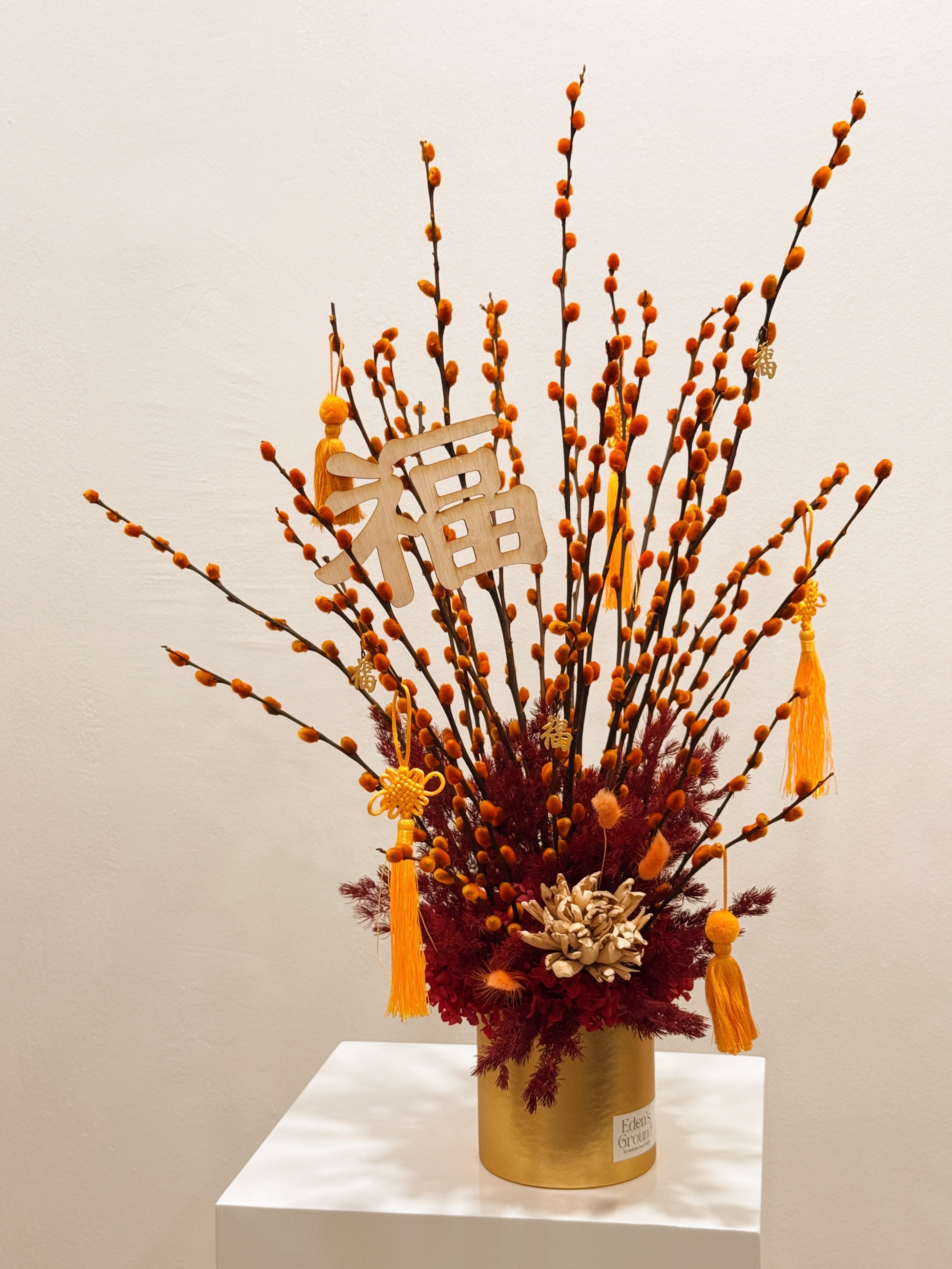Chinese New Year 2026 Pussy Willow Flower Box, featuring orange and gold pussy willow cny flower, everlasting preserved hydrangeas, decorated with red tassles and 福 to usher in wealth, abundance, prosperity and all the good vibes for the lunar new year, crafted by Eden's Ground, a floral design studio in Singapore.