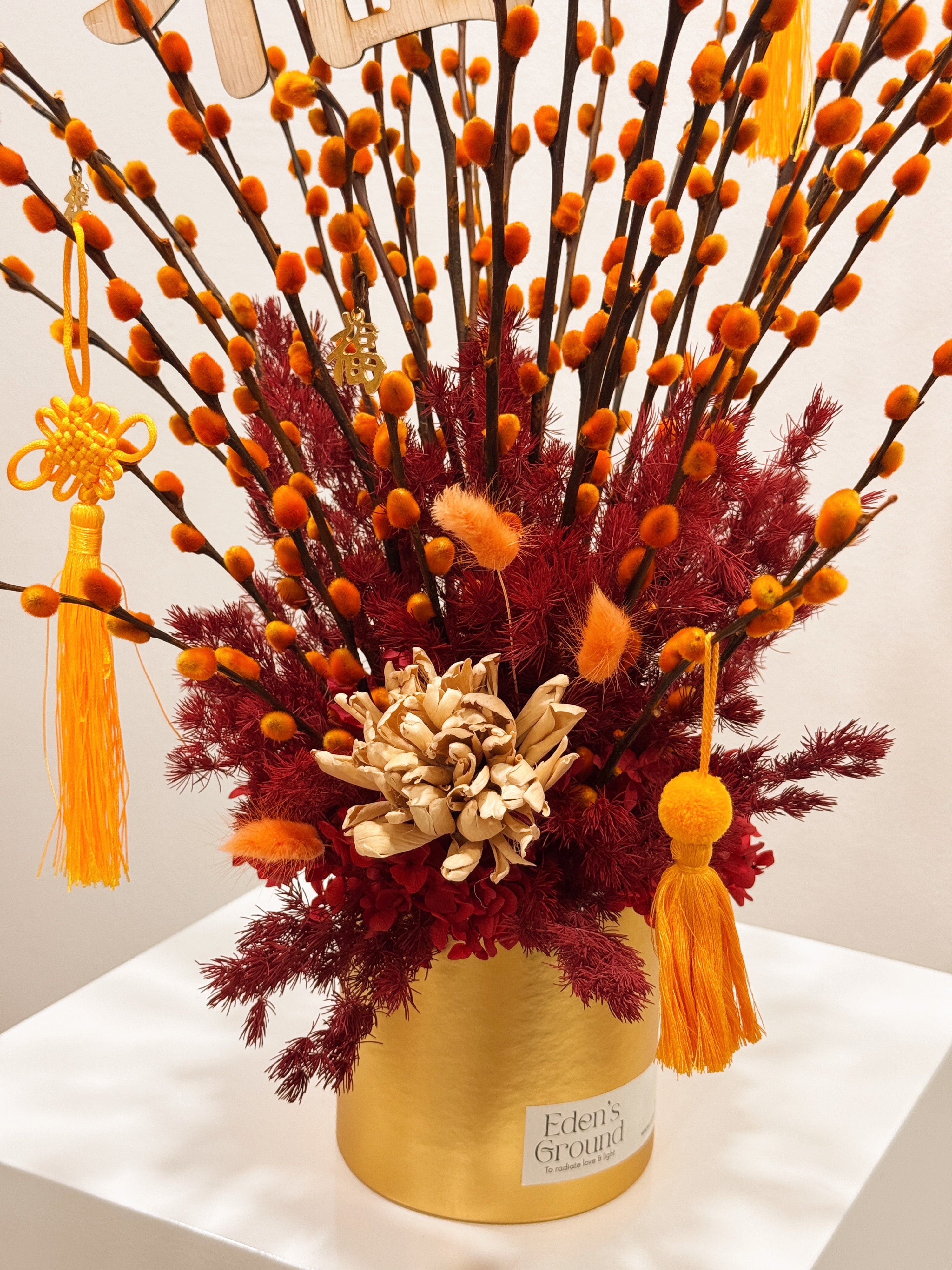 Chinese New Year 2026 Pussy Willow Flower Box, featuring orange and gold pussy willow cny flower, everlasting preserved hydrangeas, decorated with red tassles and 福 to usher in wealth, abundance, prosperity and all the good vibes for the lunar new year, crafted by Eden's Ground, a floral design studio in Singapore.