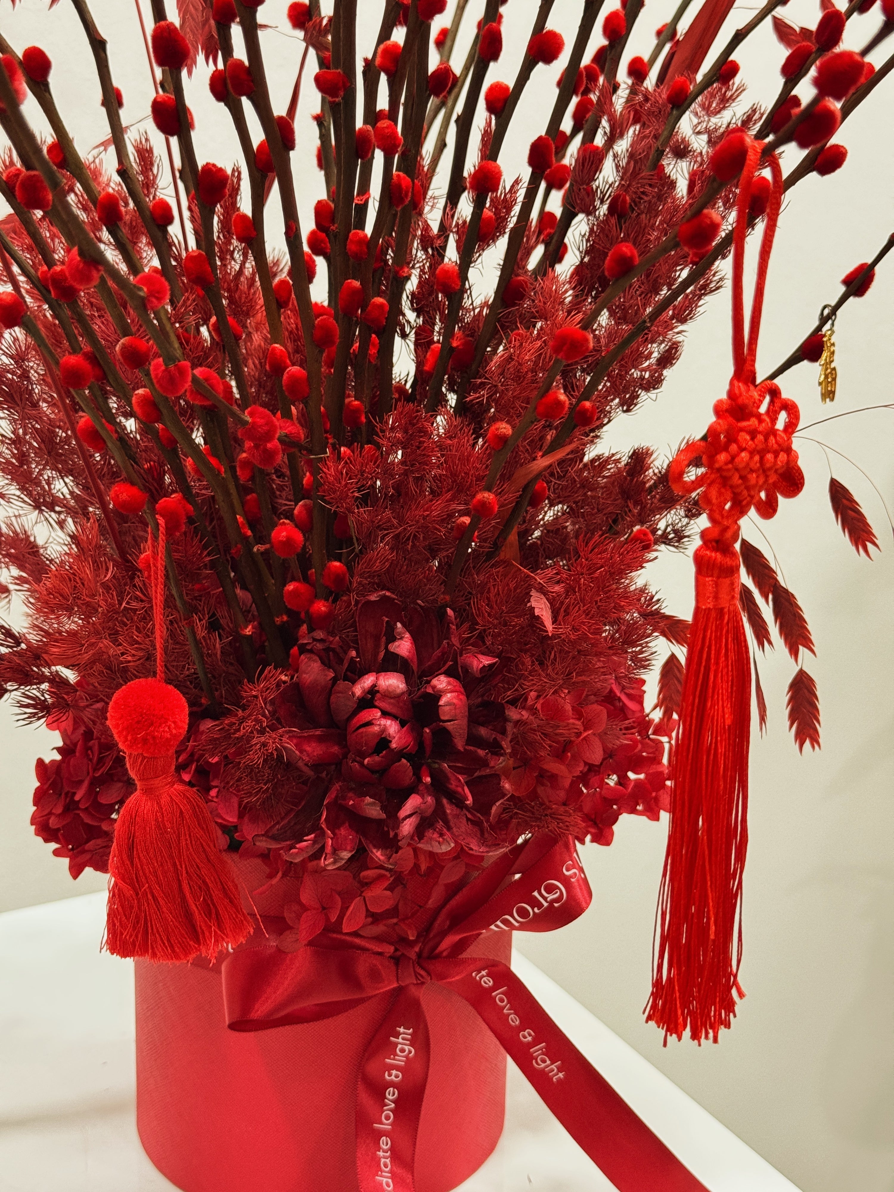 Chinese New Year 2026 Pussy Willow Flower Box, featuring red pussy willow cny flower, everlasting preserved hydrangeas, decorated with red tassles and 福 to usher in wealth, abundance, prosperity and all the good vibes for the lunar new year, crafted by Eden's Ground, a floral design studio in Singapore.